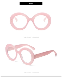 Detail view of pink oversized round frame glasses with high-quality thick acetate finish