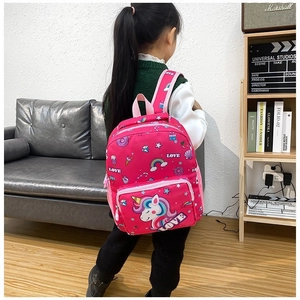 Pink unicorn kids backpack featuring rainbow and star prints worn by a little girl