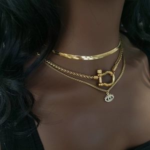 Detailed view of layered 18K gold plated necklaces with carabiner clasp and eye pendant