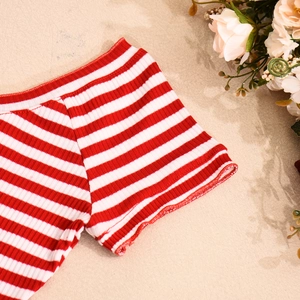 Detail of red and white striped knit fabric with soft ribbed texture and fine stitching
