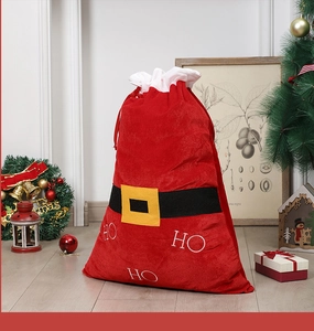 Detail of red velvet Christmas sack with HO HO HO embroidery and decorative belt buckle