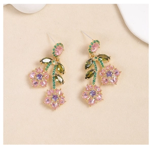 Macro shot of colorful cubic zirconia flower earrings with silver needle and leaf design