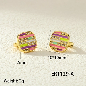 Detail view of square gold earrings with colorful enamel stripes and white rhinestones