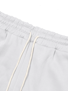 Detail of elastic waist with white adjustable drawstrings on fleece sweatpants
