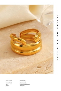 Close-up of chunky multi-layer 18K gold plated stainless steel open ring on a stone base