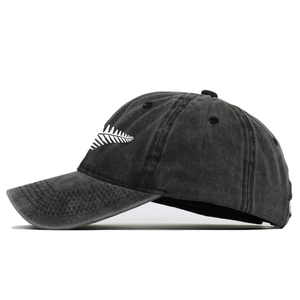 Vintage washed dark grey baseball cap with white leaf embroidery and adjustable strap