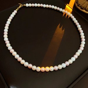 Detail of pink and white freshwater pearls with gold clasp on a luxury display box