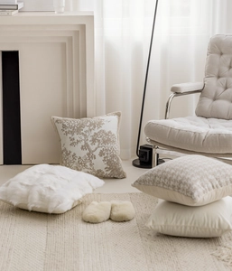 French chic beige throw pillows and plush slippers in a cozy living room setting