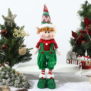 Detail of Christmas elf doll with red sequin top and green velvet suspender trousers