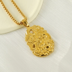 Close-up of 18K gold plated dragon pendant with box chain on white silk background