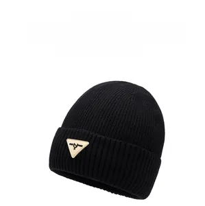 Close-up of thick ribbed knit beanie featuring a triangle leather patch detail