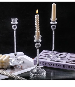 Macro shot of glass candle holder set with diamond crystal filling and diamond-cut base