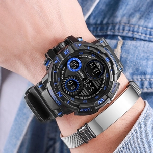 Close-up of black digital sports watch with blue accents on wrist with denim jacket