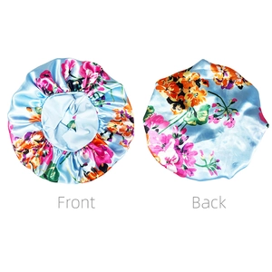 Front and back views of large floral satin sleep bonnet with wide elastic band in light blue