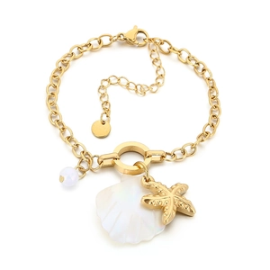 Golden ocean charm bracelet with white shells, starfish, and pearls on a white background