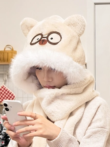 Macro detail of beige plush hood scarf showing soft faux fur texture and bear embroidery
