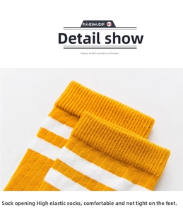 Detail of high-elastic ribbed cuffs on yellow and white striped cotton crew socks