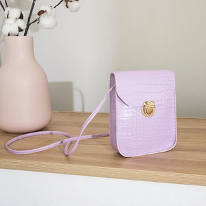 Minimalist purple crocodile pattern crossbody bag with gold metal lock on wooden surface