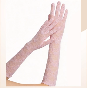 Close-up of pink floral lace gloves showing delicate patterns and semi-sheer fabric detail
