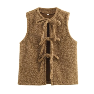 Detailed view of brown plush vest featuring three delicate front bow tie closures