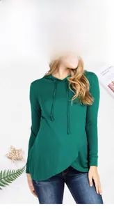 Detail of dark green maternity hoodie featuring a ruffled crossover hem and soft hood