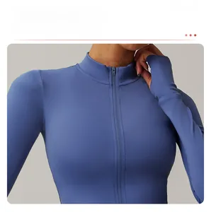 Close-up of dark blue yoga top featuring stand collar zipper and thumbhole cuffs