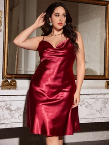 Detail view of red satin slip dress with elegant cowl neck and thin spaghetti straps