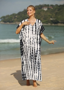 Detail of beach cover-up featuring black and white tie-dye stripes and V-neckline