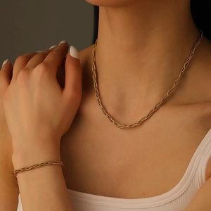 Three-layer gold round snake chain necklace and bracelet jewelry set on model