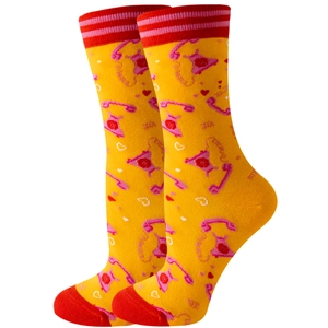 Close-up of yellow mid-calf socks with vintage telephone patterns and red toe accents