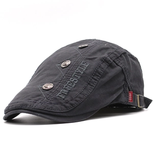Detailed embroidery on a grey cotton flat cap with side metal buttons and red logo tag