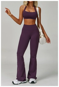 Detail of high-waisted purple flared yoga pants and racerback sports bra set