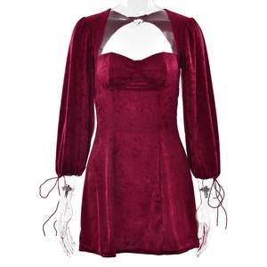 Detailed view of red velvet mini dress featuring heart neckline and cutout chest design
