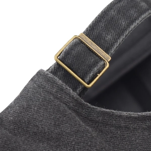 Detail of adjustable brass buckle and washed denim strap on the charcoal baseball cap