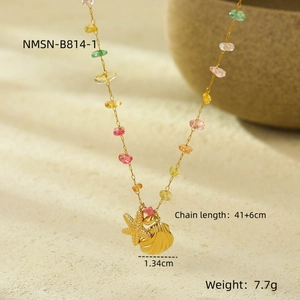 Detail of 18K gold necklace with colorful stones and starfish shell pendant charms