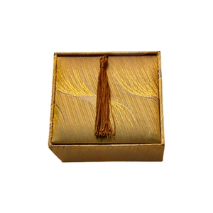 Closed square jewelry gift box with gold-brown feather texture fabric and brown tassel