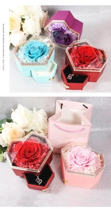 Macro view of heart-shaped preserved rose jewelry box with multi-color flower drawer