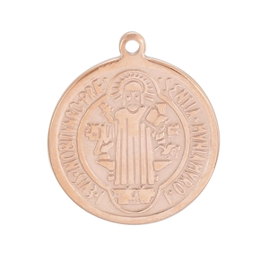 Macro shot of rose gold Saint Benedict medal pendant with detailed Latin relief