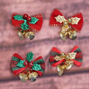 Detail of Christmas ribbon bows with gold bells in red, green, and plaid fabric styles