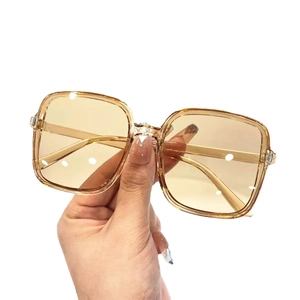 Trendy oversized square sunglasses with champagne frames and light brown gradient lenses