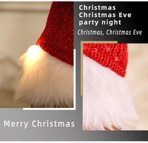 Detail of Christmas gnome glowing knitted hat with red sequins and warm LED lighting