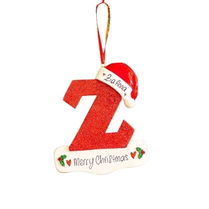 Close-up of a red glitter letter Z Christmas tree ornament with a Santa hat and Zia Anna name