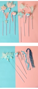 Detailed close-up of colorful steel wire cat wands with feathers and bells in pastel colors