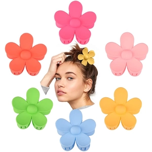 Detail of matte flower hair claws in six candy colors showing fit and variety on model