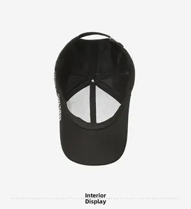 Interior view of black baseball cap showing cotton fabric and breathable mesh panels