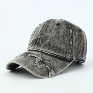 Close-up of distressed denim baseball cap showing vintage frayed edges and washed texture