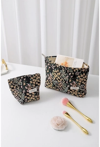 Detail of floral canvas makeup bags in two sizes with metal zipper and H & R BAG label