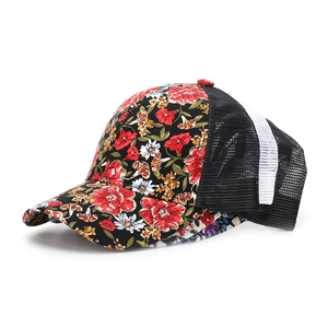Detail of floral baseball cap showing breathable mesh and golden edge flower patterns