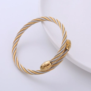 Two-tone silver and gold twisted cable wire bracelet with polished metal end caps