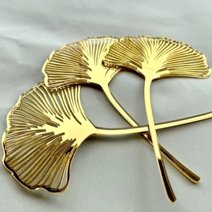Golden acrylic ginkgo leaf cake toppers for elegant birthday party decorations